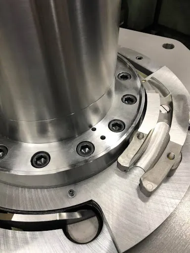 An overhead view of the filling station of a rotary tablet press.